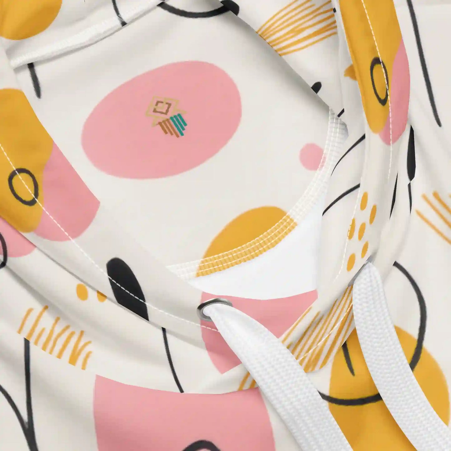 Close-up views of the white hoodie fabric, drawstring and eyelet, hood lining, and stitching details. Highlights the quality of the print on the fabric and garment construction, showing the abstract pattern detail.